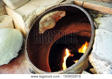 Pita Bread cooking in the Taboon Oven.