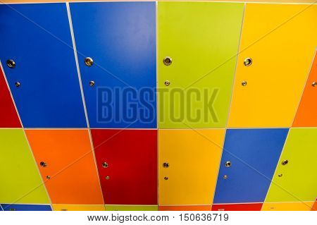 Wooden multi color painted school lockers in hallway