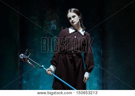 Portrait of a young girl with drop counter as a vampire woman against school board . The image in the style of Halloween