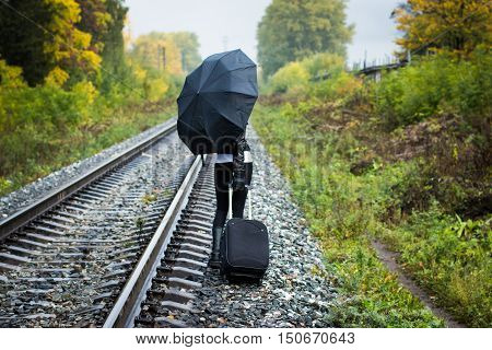 Girl, Umbrella And Rails In Autumn Day