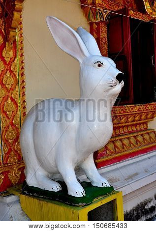 Lamphun Thailand - December 28 2012: Carved figure of a giant white rabbit stands outside the Ubosot sanctuary hall at Wat Doi Ti