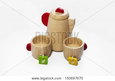 Still life of the wooden teapot and tow cups isolated on white background.