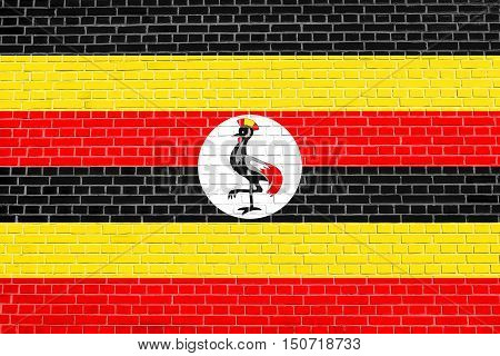 Ugandan national official flag. African patriotic symbol banner element background. Flag of Uganda on brick wall texture background, 3d, illustration
