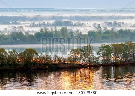 Dawn on the Volga river. Morning fog covers the coast.