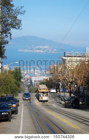 SAN FRANCISCO, CA - DEC 29: Cablecar in San Francisco, with Alcatraz in the background on December 29, 2008 in San Francisco, California, USA.