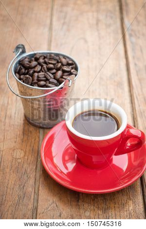 Red cup of espresso on wooden table stock photo