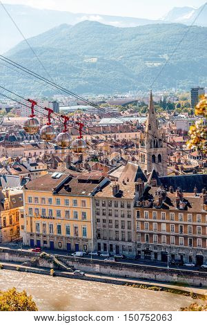 Grenoble, France - June 21, 2016: Morning cityscape view on the old town with cable car and mountains in Grenoble city on the south-east of France
