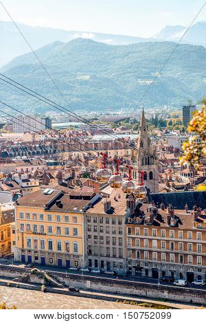 Grenoble, France - June 21, 2016: Morning cityscape view on the old town with cable car and mountains in Grenoble city on the south-east of France
