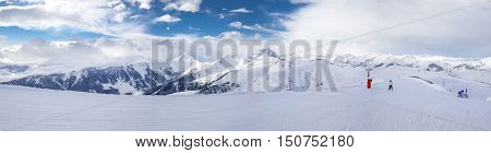 Panoramaview To Ski Slopes And Skiers Skiing In Kitzbuehel Mountain Ski Resort With A Background To