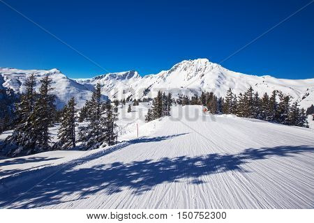 View to Alpine mountains surrounded by fog and ski slopes in Austria from Kitzbuehel ski resort with 54 cable cars 170 km prepared skiing slopes and place of famous hahnenkamm races.
