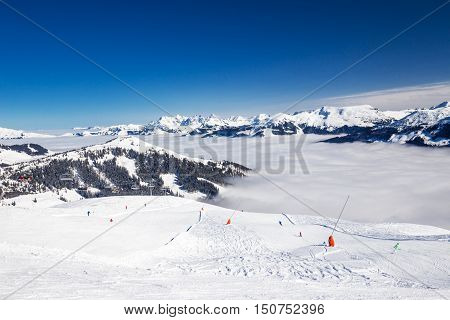 View to Alpine mountains and ski slopes in Austria from famous Kitzbuehel ski resort with 54 cable cars 170 km prepared skiing slopes and place of famous Hahnenkamm races.