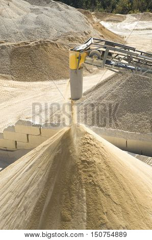 Working belt conveyor and a piles of stone meal in Gravel Quarry