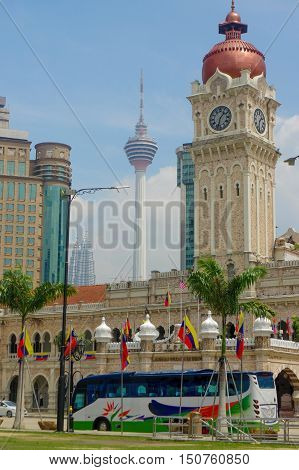 KUALA LUMPUR, MALAYSIA - January16. 2016: Clock tower of Sultan Abdul Samad building near Merdeka Square and the LK Tower in background.