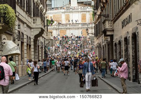 ROME ITALY - JUNE 15 2015: Spanish Steps and Via Condotti in Rome. This street is the center of fashion shopping in Rome with the atelier of Bulgari Armani Cartier Fendi Gucci and others.