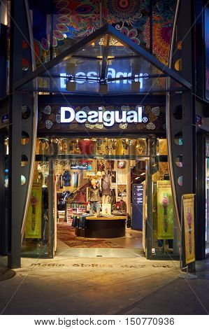 GENEVA, SWITZERLAND - NOVEMBER 18, 2015: a Desigual store at night. Desigual is a clothing brand headquartered in Barcelona, Spain.
