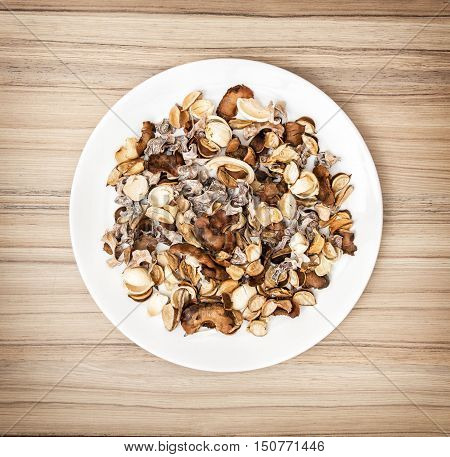 Decoration of dried flowers on the round white plate. Natural beauty. Spa theme. Potpourri scene.