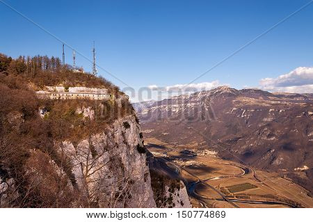 Aerial view of the Adige Valley in winter with the highway and cultivated fields and the plateau of Lessinia on background Veneto Italy