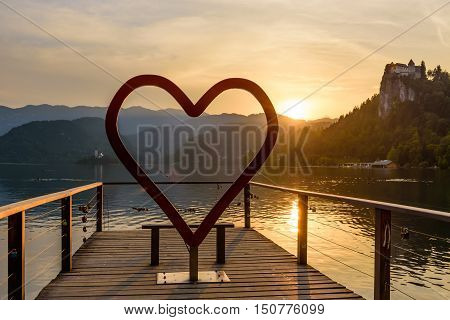 The heart symbol on the picturesque shore of Bled lake at sunset, Bled village, Slovenia.