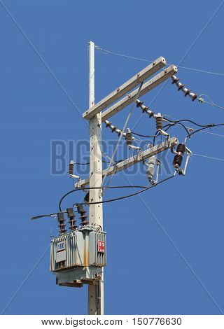 High Voltage Pole with Transformer isolated on Blue Background