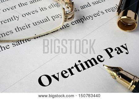 Overtime pay concept written on a paper.