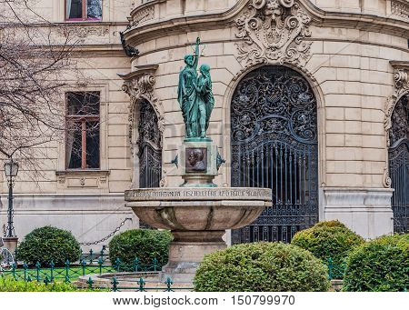 BUDAPEST, HUNGARY - FEBRUARY 21, 2016: Fountain on the background the facade of Metropolitan Ervin Szabo Library is the largest library network in Budapest Hungary.