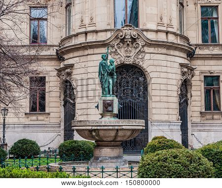 BUDAPEST, HUNGARY - FEBRUARY 21, 2016: Fountain on the background the facade of Metropolitan Ervin Szabo Library is the largest library network in Budapest Hungary.