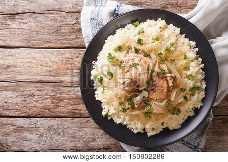 Yassa Chicken With Onions And Garnished With Couscous Closeup. Horizontal Top View
