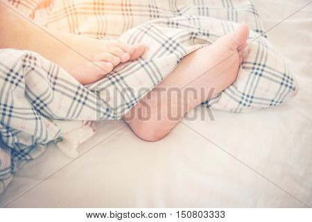 Close Up Feet Of Women Sleeping  On Bed In Morning
