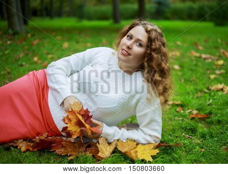beautiful young plussize model in the autumn park