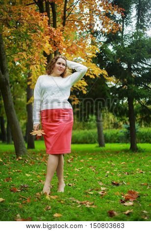 beautiful young plussize model in the autumn park