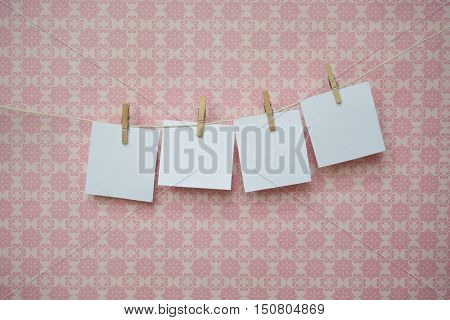 White Sheets Of Paper On A Pink Background, White Sheets On Clothespins