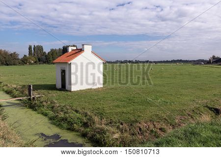 Little house with electricity equipment in Dutch rural landscape