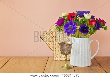 Jewish holiday Passover background with matzoh and spring flowers