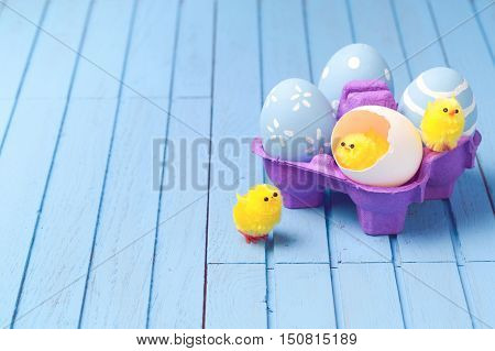Easter holiday creative background with painted eggs and easter cute chicks