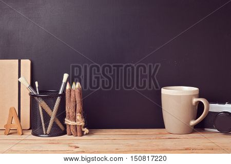 Website header design with designer vintage desk over chalkboard background