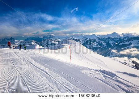 Skiers skiing in Steinbergkogel - Kitzbuehel ski resort with 54 cable cars 170 km prepared skiing slopes and place of famous hahnenkamm races