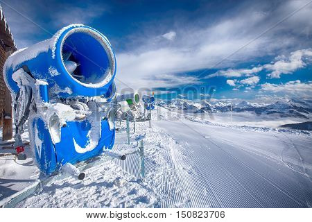 Snow cannons with fresh prepared ski slopes with the corduroy pattern in Kitzbuehel ski resort.