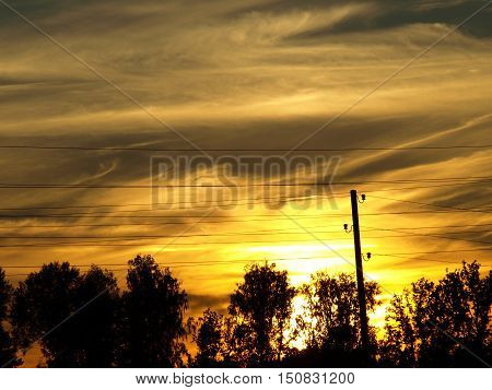 Sunset on a cloudy summer where you can see the cover of the power cord