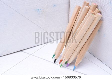 Group of sharp wooden crayons closeup in box
