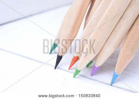 Group of sharp wooden crayons closeup in box