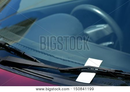 Parking ticket on car windscreen. transportation and vehicle concept