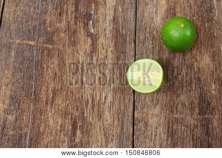 lemon fresh green and slice lime on wooden table top view