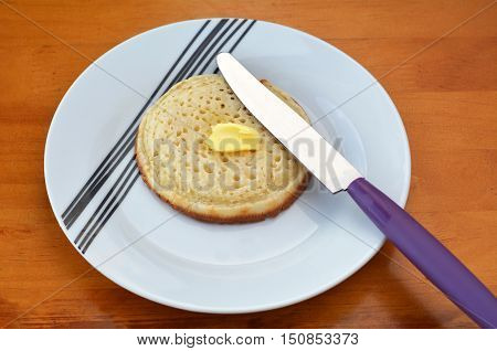 Buttered English Crumpet With Knife