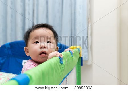 Asian Baby In Playpen
