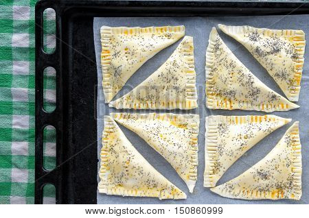 Triangular Bourekas ready to be cooked in the oven