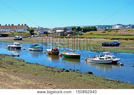 AXMOUTH, UNITED KINGDOM - JULY 18, 2016 - Fishing boats moored along the River Axe Axmouth Devon England UK Western Europe, July 18, 2016.