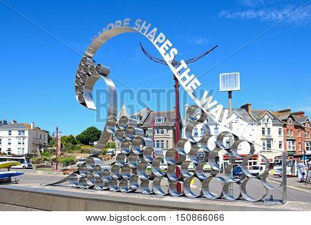 SEATON, UNITED KINGDOM - JULY 18, 2016 -Metal Waves Shape The Shore sculpture at the entrance to the beach Seaton Devon England UK Western Europe, July 18, 2016.