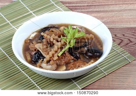 Mixed vegetable and tofu sheet in brown soup call 