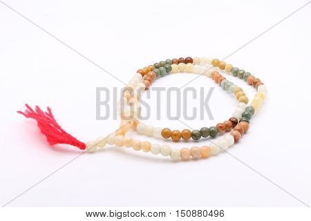 Bead Necklace with Red Tassel on White Background