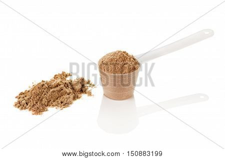 Product photograph of scoop of whey protein with visible texture and mirror reflection